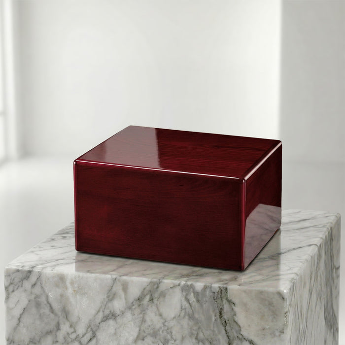 Red cube-shaped box on a marble surface with a white background