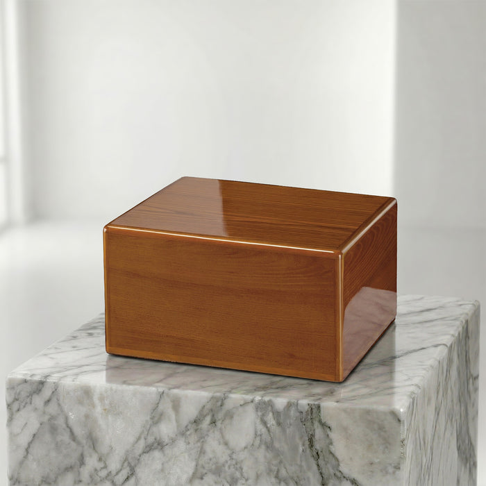Wooden box urn on a marble surface with a white background