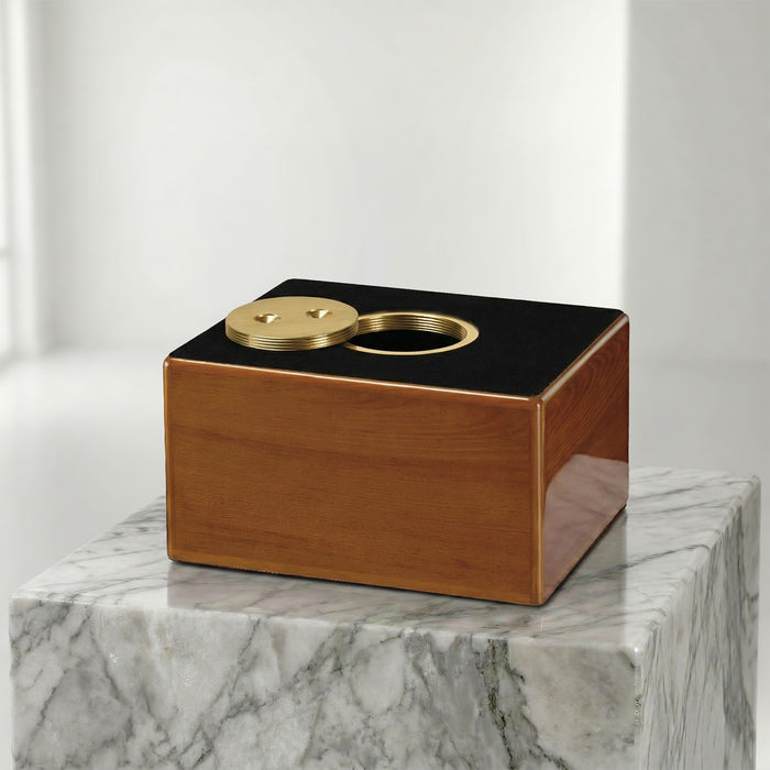 Wooden box urn and brass cylindrical insert on a marble surface with a white background