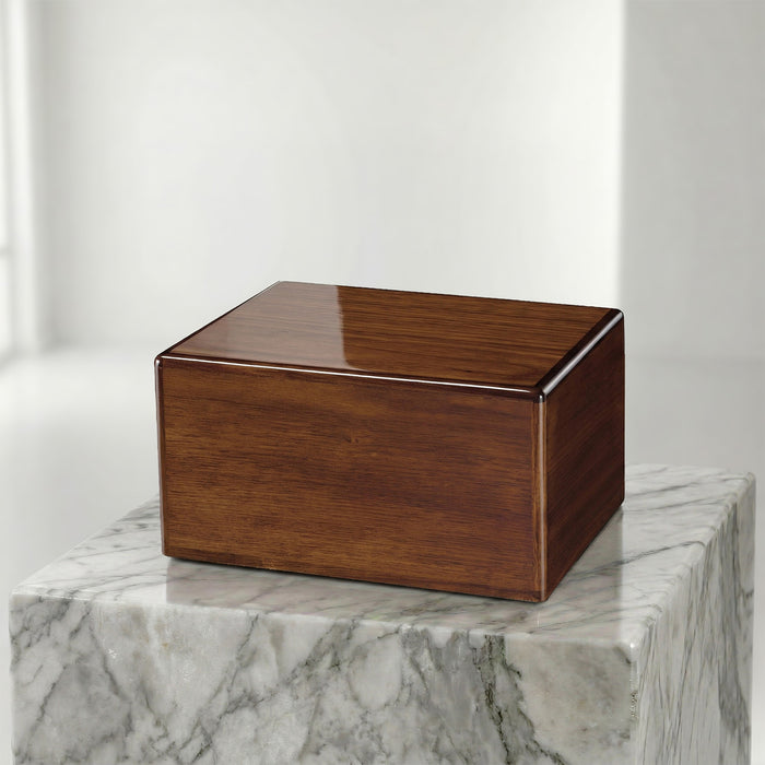 Wooden box urn on a marble surface with a white background