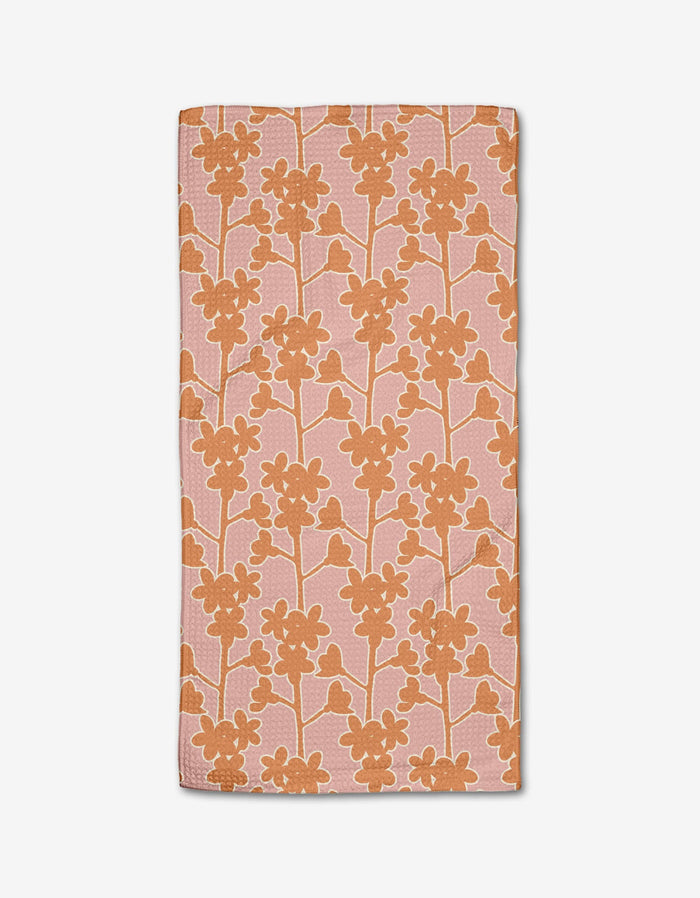 The Cherry Blossom Branches bar towel by Lizzie Clark features a rectangular pink design with an orange floral pattern, made from Geoweave fabric and recycled materials, shown on a white background.