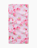 The Cherry Blossom Bar Towel by Rebecca Bobko is crafted from Geoweave fabric and features a pink background with overlapping pink, red, and white abstract floral shapes, plus hints of green and yellow.