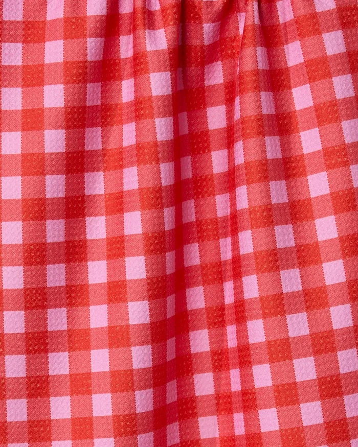 A close-up of GEOMETRYs Cherry Gingham fabric, showcasing its red and pink checkered pattern made from recycled materials with gentle gathers at the top.