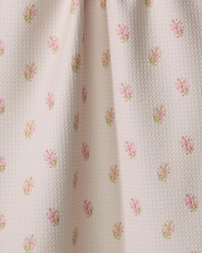 Close-up of Cindy by Kelsi Fullmer—an ultra-absorbent white fabric softly gathered in the center, featuring a repeating pattern of small pink rose bouquets and green leaves, perfect for a charming tea towel.