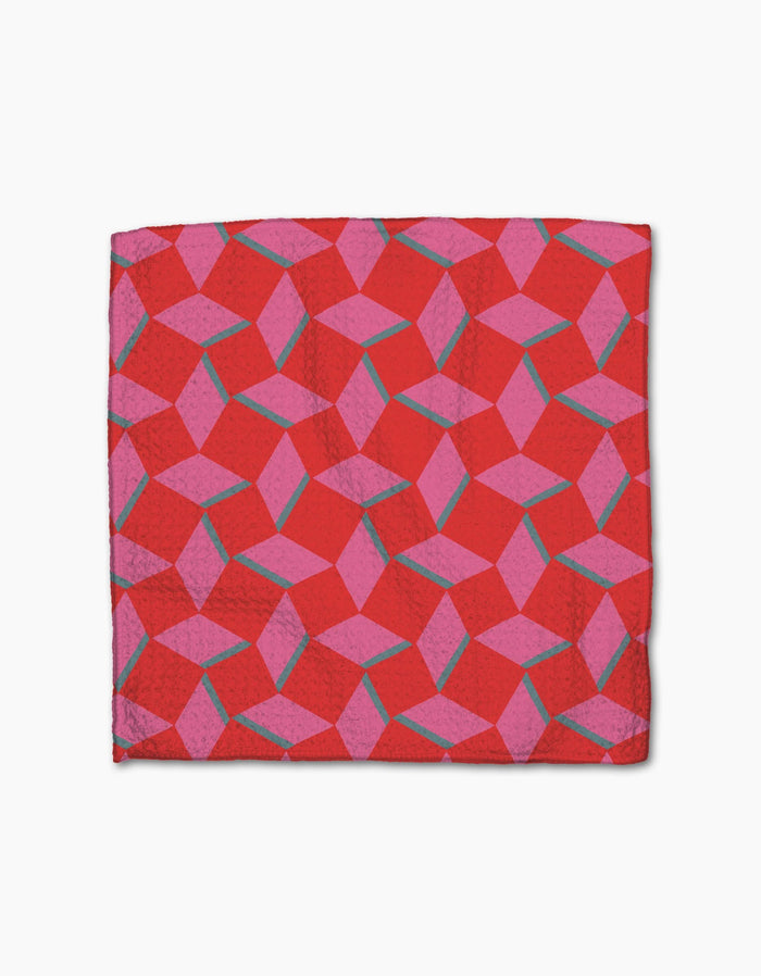 The Circus Stand napkin by Geometry is made from Geoweave fabric and features a geometric pattern in pink and purple with interlocking shapes and thin teal lines on a bright red background.