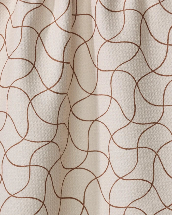 Clarity by Gerdadzy is a beige, textured tea towel made from recycled materials, featuring thin wavy brown lines in abstract shapes—ultra-absorbent and stylish for any kitchen.