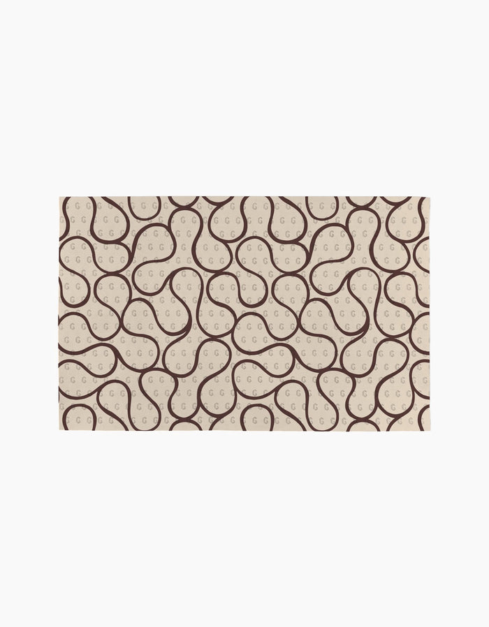 Coffee Reverie by Gerdadzy is a rectangular beige rug with a repeating abstract pattern of dark brown curves and dotted loops, creating an organic, wavy look—ideal for pairing with eco-friendly kitchen towels or recycled paper towels.