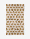 The Purely Kaylie Cookie Crumble tea towel, crafted from Geoweave fabric, showcases an all-over chocolate chip cookie pattern and is displayed flat.