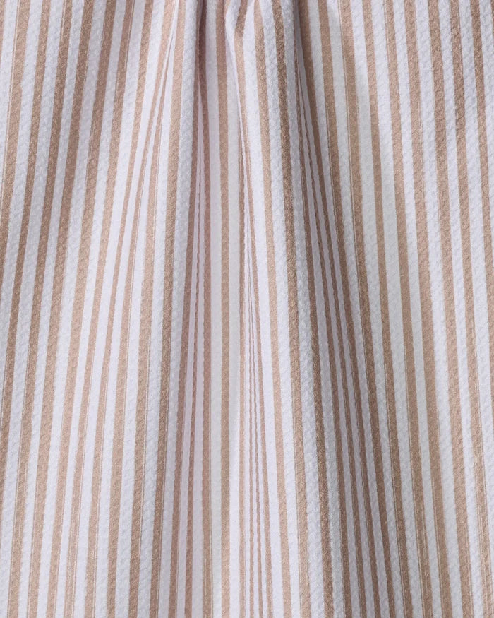 Close-up of the "Cookie" tea towel by Kailee Wright, featuring vertical beige and white stripes in varying widths. This absorbent dish towel adds a subtle, charming pattern—perfect for bringing style to your kitchen.