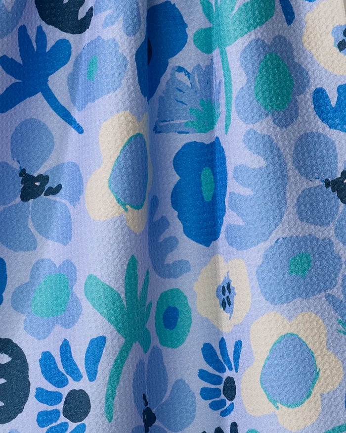 Close-up of Cool Blooms by Sareka Unique: textured fabric made from recycled materials, with a vibrant abstract floral pattern in blue, teal, green, and cream on light blue—a lively design perfect for a quick-drying tea towel.
