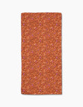 Coral Swirls by Geometry: a rectangular orange bar towel with swirling lines and abstract shapes in dark orange and light purple, crafted from premium Geoweave fabric, displayed on a white background.