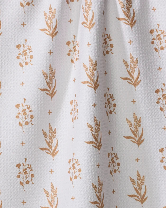 Country Road by Charlie Rowan Designs: White textured fabric made from recycled materials, adorned with golden brown floral sprigs and plus signs in neat rows—perfect as an eco-friendly kitchen towel.