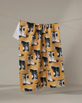 Cowboy Boots by Megan Roy, crafted from quality materials in a mustard yellow hue with bold black and white abstract details, rest with soft shadows and gentle curves against a neutral background.