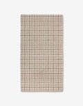 The Crossover by Studio Jeannot is a rectangular beige textile featuring a grid of light brown and white lines with small square and rectangular accents. Made with Geoweave technology, it offers a soft, textured, and highly durable surface.