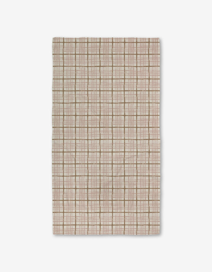 The Crossover by Studio Jeannot is a rectangular beige textile featuring a grid of light brown and white lines with small square and rectangular accents. Made with Geoweave technology, it offers a soft, textured, and highly durable surface.