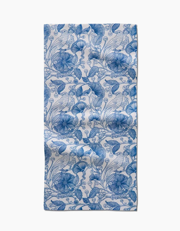 The Crowberries bar towel by Katie OShea features a blue floral and leaf pattern on white Geoweave fabric, with intricate repeating botanical designs and visible fabric folds.