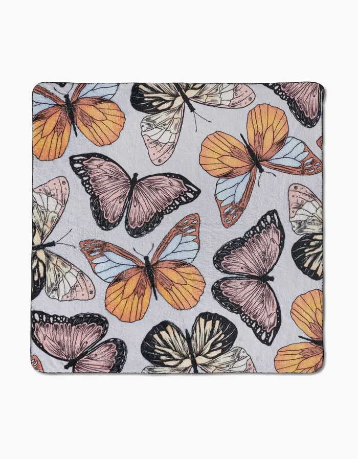 Geometry’s “Cute Butterflies” is a square recycled fabric featuring a colorful butterfly pattern in orange, yellow, pink, and black on a light gray background.