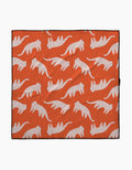 The Cute Cheetah blanket by Jennifer Bouron is lightweight and eco-friendly, featuring a repeating pattern of white cats with pink spots in a walking pose on an orange background.