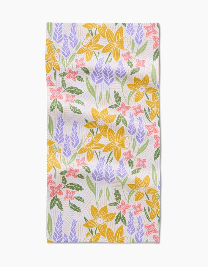 Daffodil Dreams by Sarah Daugherty: a rectangular bar towel featuring yellow daffodils, purple lavender, pink flowers, and green leaves on white Geoweave fabric for superior absorbency.