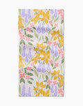Daffodil Dreams by Sarah Daugherty: a rectangular bar towel featuring yellow daffodils, purple lavender, pink flowers, and green leaves on white Geoweave fabric for superior absorbency.