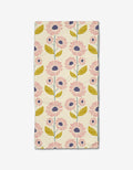 The Daisy Mays bar towel by Lizzie Clark is made from Geoweave fabric and features pink and navy flowers with green leaves and stems in vertical rows on a beige background.