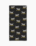 The Geometry Dalmatian In Boots Black bar towel features rows of Dalmatian dogs in yellow boots on a black background. Made from recycled materials, the dogs are evenly spaced in a repeating rectangular pattern.