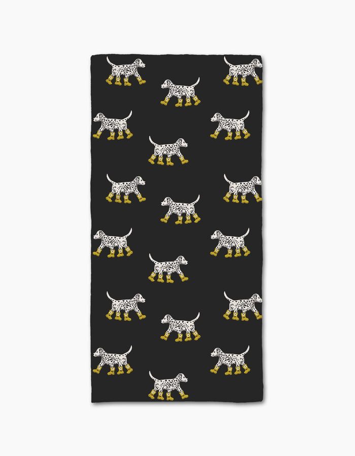The Geometry Dalmatian In Boots Black bar towel features rows of Dalmatian dogs in yellow boots on a black background. Made from recycled materials, the dogs are evenly spaced in a repeating rectangular pattern.