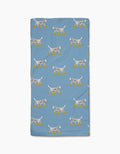 Geometry’s “Dalmatian In Boots Blue” towel features a blue, ultra-absorbent design with cartoon Dalmatian dogs in yellow rain boots on a white background.