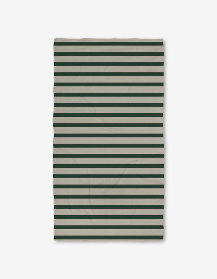 The GEOMETRY Deep Green Stripes Luxe Bath Towel, made from recycled materials and featuring horizontal dark green and beige stripes, is shown flat on a white background.