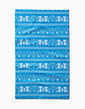 The Delft Blue Easter Stripe towel by Sarah Daugherty is quick-drying and features white horizontal patterns of bunnies, birds, flowers, and decorated eggs in repeating rows on a blue background.