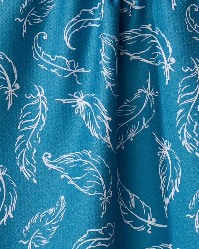 The Delicate Feathers tea towel by Elena Fay features blue fabric with scattered white hand-drawn feathers. Made from quick-drying, recycled materials, it offers eco-friendly style and dynamic texture for your kitchen.