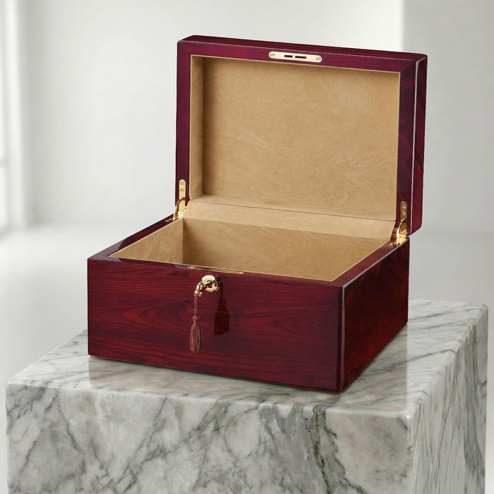 Wooden jewelry box with gold accents on a marble surface
