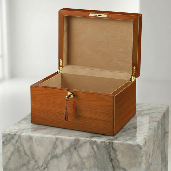 Wooden urn box with a gold clasp on a marble surface