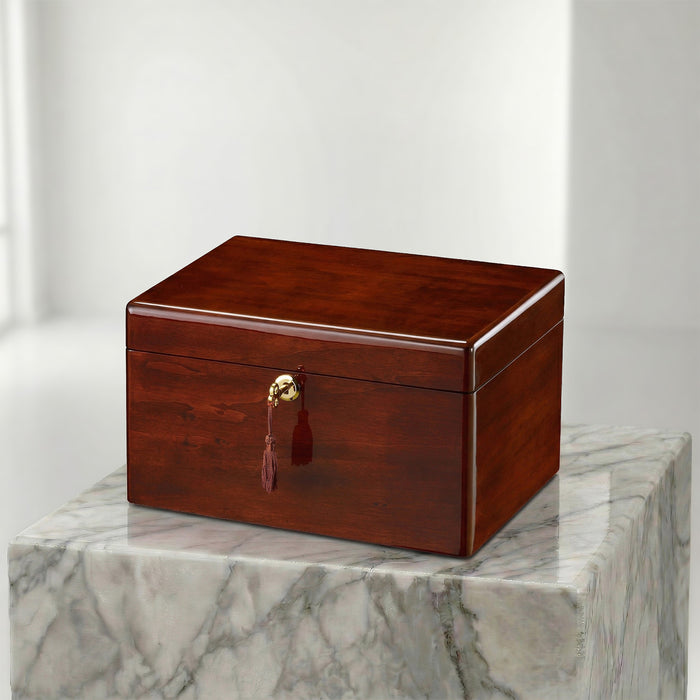 Wooden urn box with a gold clasp on a marble surface