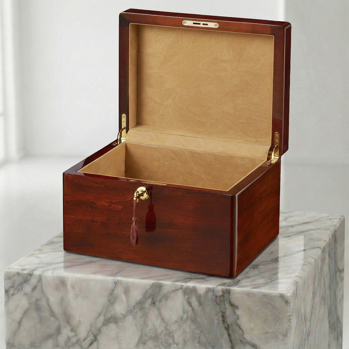 Wooden urn box with gold accents on a marble surface