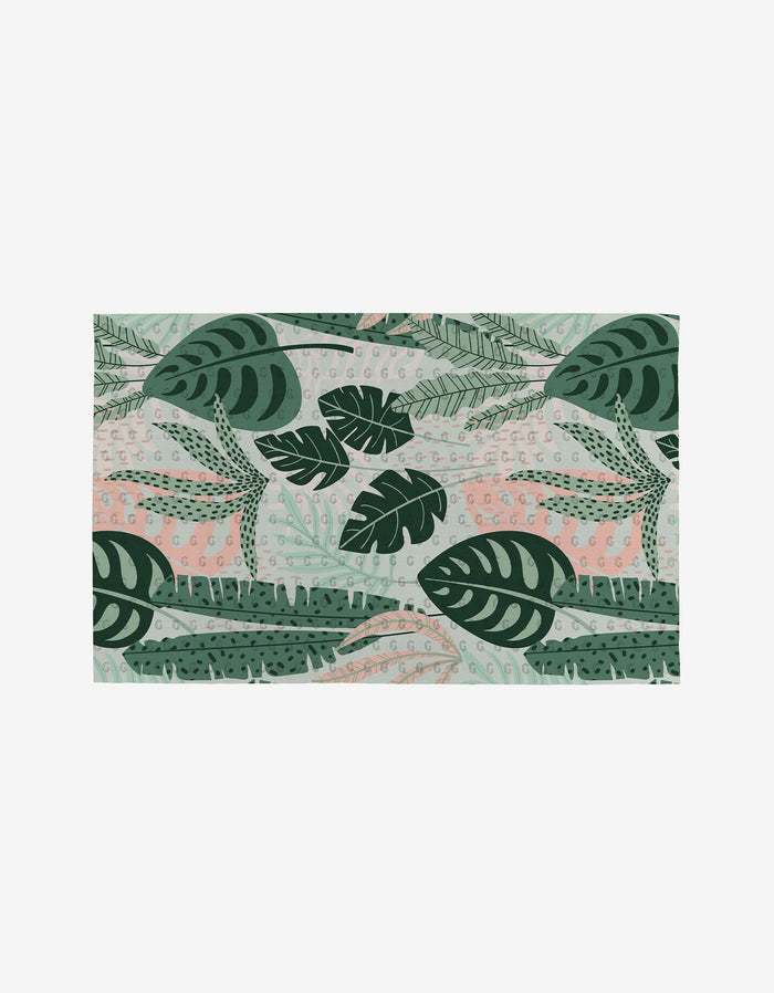 Diedre by GEOMETRY features a rectangular design of layered green tropical leaves with light pink on a pale background—an ideal eco-friendly pattern for reusable products like Not Paper Towels.