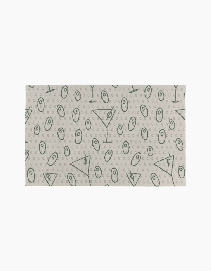 The Dirty Martini by Rosa Kichline is a rectangular cloth with a beige background and green geometric symbols, including circles, triangles, lines, and small Gs—an eco-friendly and stylish alternative to paper towels for your home.