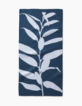 The Doghobble by PrintedPlant is a dark blue bar towel made from recycled materials, featuring a vertical white silhouette of a leafy plant design at its center.