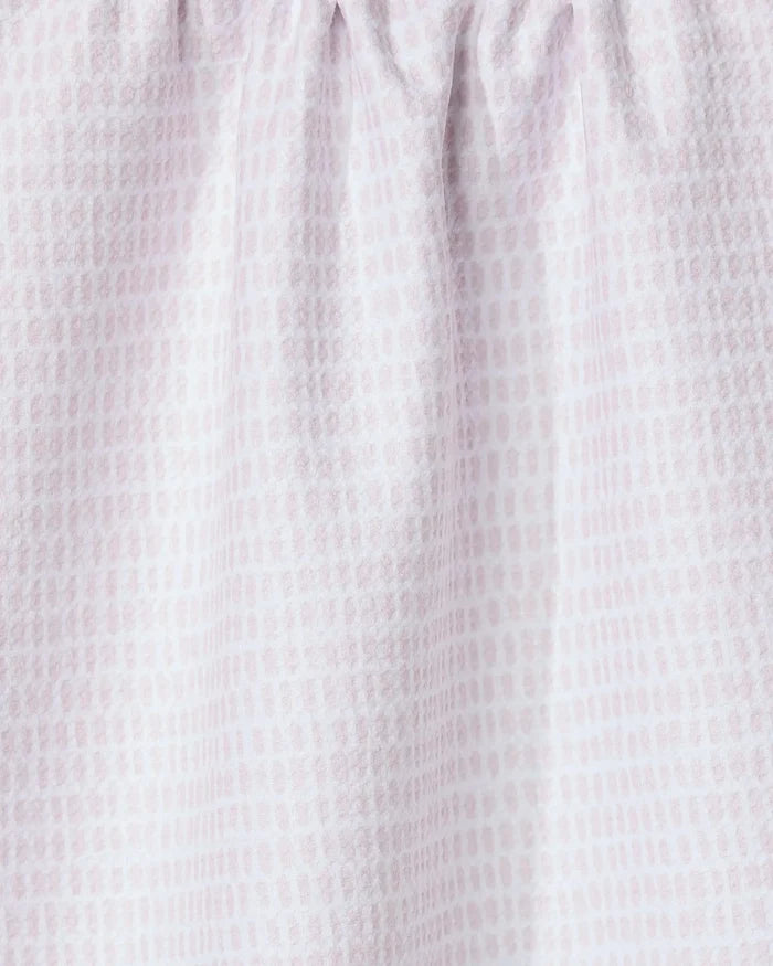 Close-up of Geometry’s Dot Dot Dot Blushed Bergamot kitchen towel, made from recycled fabric in light pink and white with a subtle grid-like dotted pattern. The gathered top creates soft folds and a textured look.