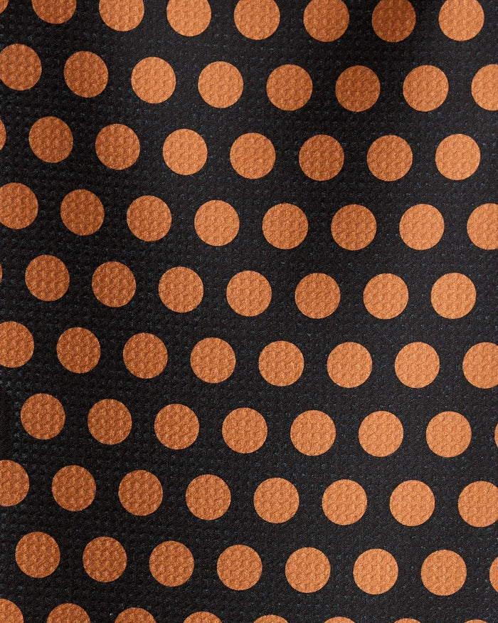 Close-up of Geometry’s Dot Noir bar towel, crafted from recycled materials. It features evenly spaced orange polka dots on a black background and a textured, ultra-absorbent fabric.