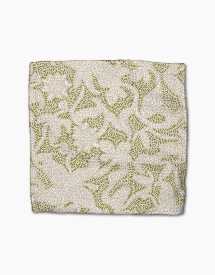 The Dotted Floral Garden by Geometry is a square fabric with a white background and intricate green and beige floral embroidery, crafted from recycled materials.