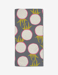 The Dragon Fruit Frolic Bar Towel by Lizzie Clark is made from Geoweave fabric and features a repeating pattern of dragon fruit slices with white flesh, black seeds, pink rinds, and green leaves on a dark gray background.