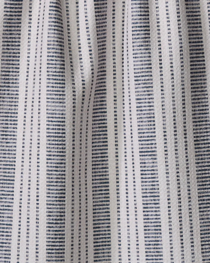 The Dyer Blue tea towel by Becki Owens features white fabric with vertical rows of small blue rectangular dots for a striped look. Ultra-absorbent and gently gathered, it adds style and function to any kitchen.