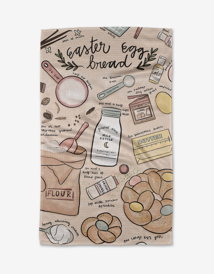 The Easter Egg Bread tea towel by Janna Sue Design features baking tools, flour, butter, eggs, milk, a measuring cup, and braided bread illustrations on ultra-absorbent Geoweave with handwritten recipe notes.