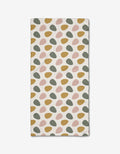 The Egg Hunt bar towel by Charlie Rowan Designs features irregular oval patterns in mustard yellow, blush pink, and sage green on soft Geoweave fabric, arranged in diagonal rows across a white background.