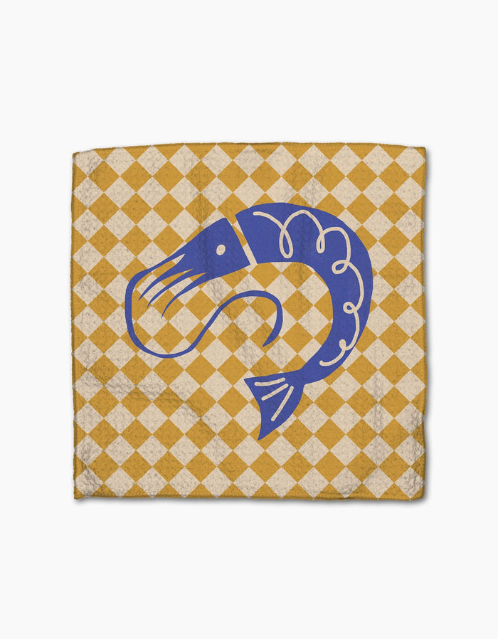 The Geometry El Mar Dos napkin features a yellow and white checkered design, a blue shrimp illustration at the center, and is made from super-absorbent Geoweave fabric.