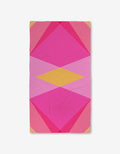 The GEOMETRY Electric Pink Luxe Bath Towel features a bold geometric pattern with overlapping pink, magenta, and yellow shapes on white, crafted from ultra-absorbent Geoweave fabric.