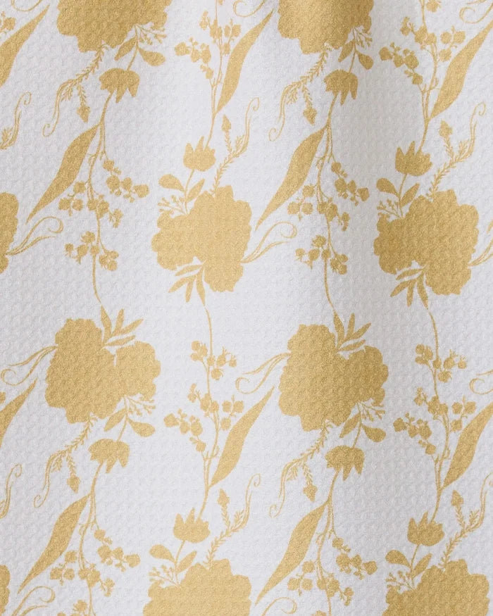 The GEOMETRY Eternal towel features a gold floral pattern with stylized flowers and leaves on textured white fabric—an ultra-absorbent, chic bar towel ideal for any stylish setting.