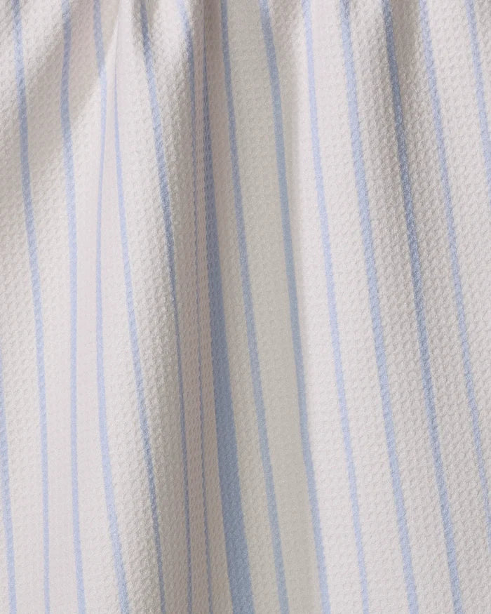 Close-up of the Becki Owens Eve Stripe dish towel, made from light-colored fabric with vertical blue and white stripes. The textured surface has gentle folds and soft shadows.