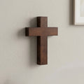 Wooden cross on a plain wall